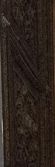A detail: a dark carved-bronze door.