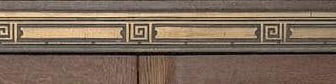 A detail: a warm wood frame with an ornamented brass band.